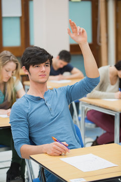 Student raising hand during exam
