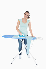 Smiling woman ironing jumper