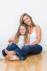 Mother and daughter sitting on the floor