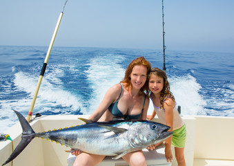 bikini fisher woman and daughter with bluefin tuna © lunamarina