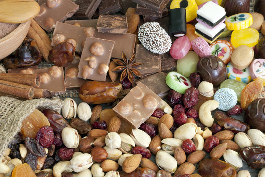 Chocolate Nuts Dried Fruits And Candy Background