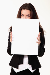 Happy smiling young business woman showing blank signboard, over