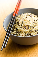 wild rice in ceramic bowl and chopsticks