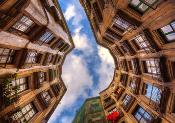 Looking up surrounded by old buildings in Barcelona. Spain.