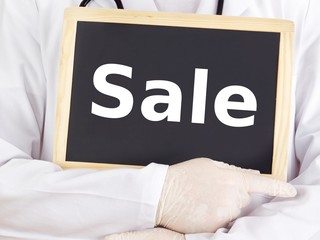 Doctor shows information on blackboard: sale