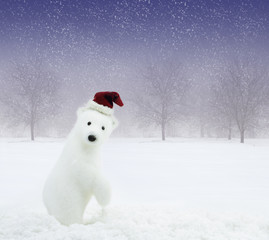 White bear with Santa Claus hat in snowy field