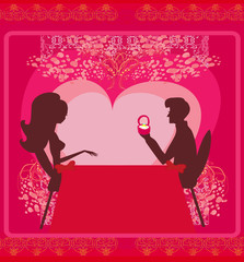 man proposing with an engagement ring to his love in a restaura
