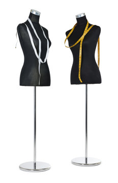 Two female mannequin with a tape measure on white background