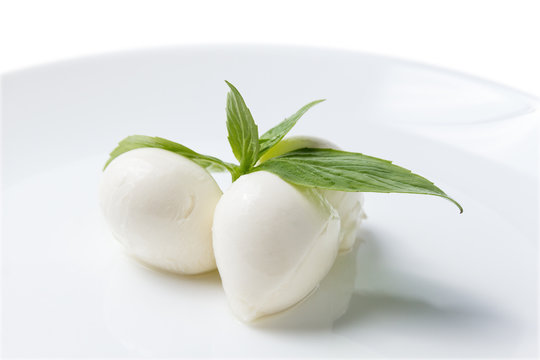 just balls of mozzarella cheese with leaves of basil