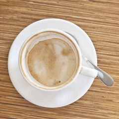Morning coffee cup on wood table in shop