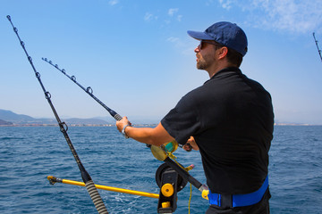 blue sea fisherman in trolling boat with downrigger © lunamarina