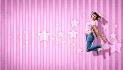 young woman dancing and jumping...