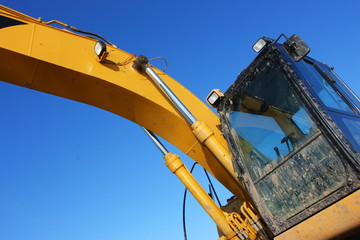 Hydraulic excavator against a blue sky © argot