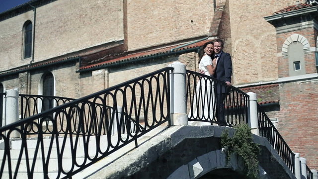 Happy just married couple on the bridge in Venice