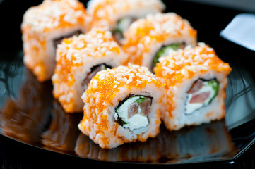 Geisha rolls on a black plate, horizontal shot, close-up