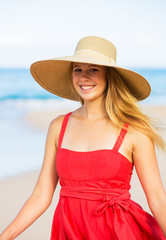 Happy Beautiful Woman in Red Dress on the Beach