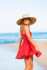 Happy Beautiful Woman in Red Dress on the Beach