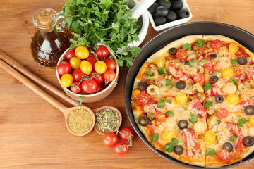 colorful composition of delicious pizza, vegetables and spices