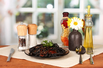 Black spaghetti on bright background