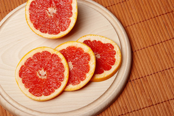 Grapefruit slices on chopping board