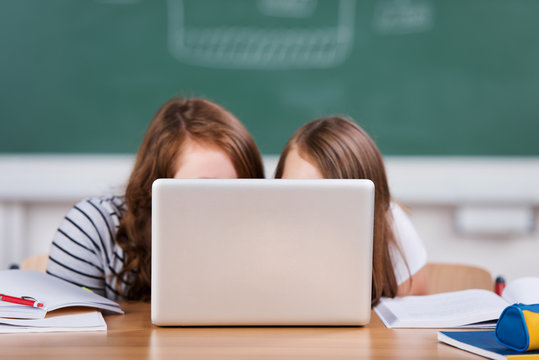 zwei schülerinnen schauen auf den laptop