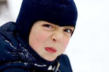 Winter portrait of angry boy