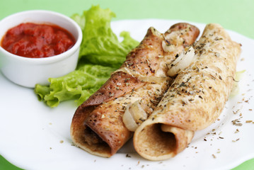 Appetizing fried pancakes with a tomato sauce