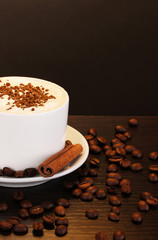 Latte on wooden table on brown background