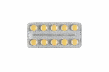 yellow pills on white isolated background