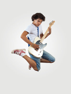 Young Man Playing On Electro Guitar And Jumping