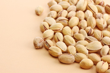 tasty pistachio nuts, on beige background