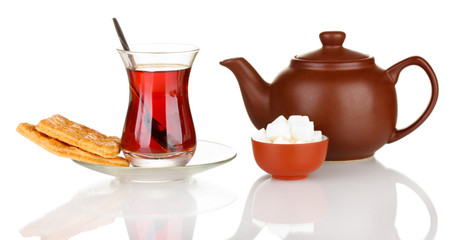 glass of Turkish tea and kettle isolated on white