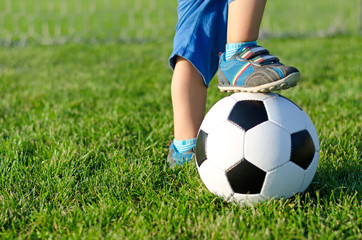 Boy with his foot on a soccer ball