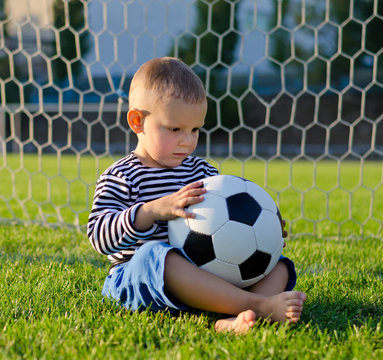 Little boy in the goal with his soccer ball