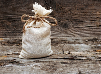 coffee beans and burlap sack on wooden background