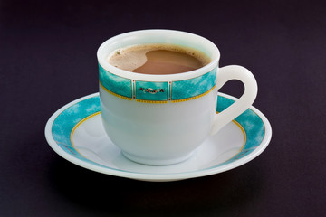 Cup of coffee on a black table.