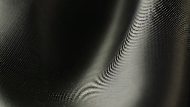 background of black satin fabric closeup