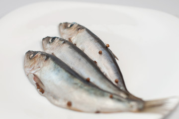 three small herrings on the plate