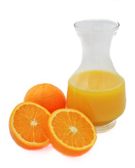 Jug orange juice with oranges isolated on white