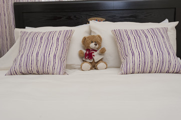 Teddy bear on a bed