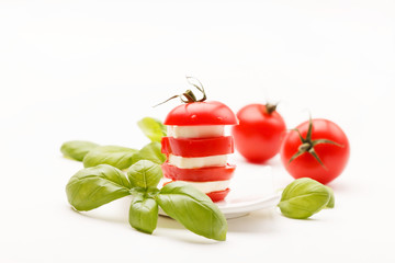 tomato and mozzarella slices decorated with basil leaves