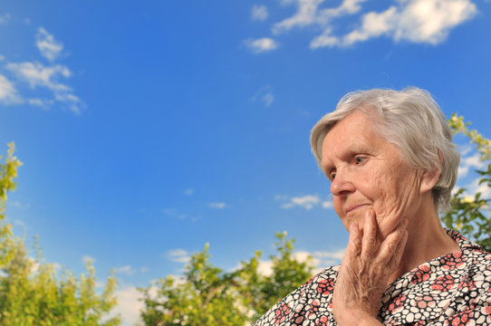 Senior woman - thinking, outdoors.