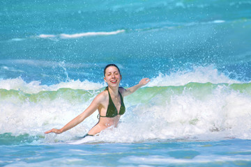 Happy girl splashing in the waves