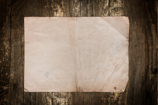 Dark paper sheet on a vintage wooden background