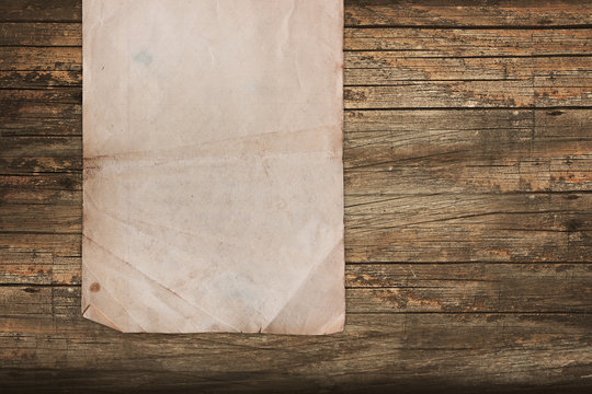 Faded paper roll on a wooden background