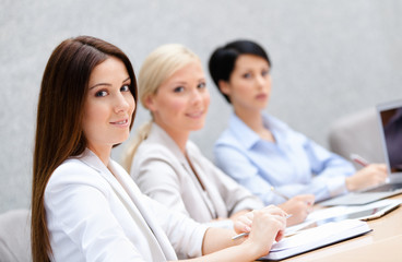 Colleagues discuss business plan sitting at the meeting hall