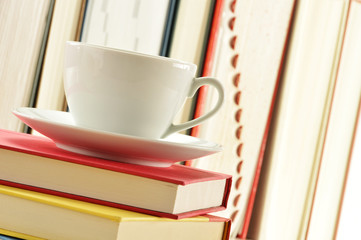 Composition with stack of books and cup of coffee