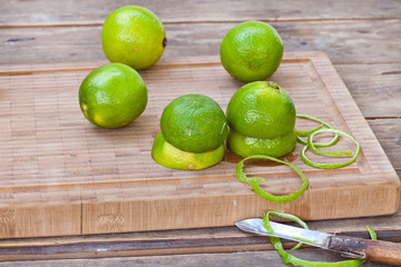 Fresh limes on wooden background