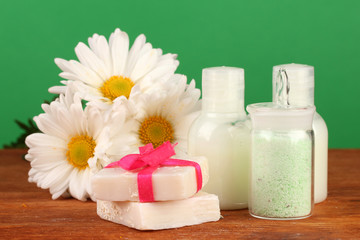 Obraz na płótnie Canvas ingredients for soap making on green background