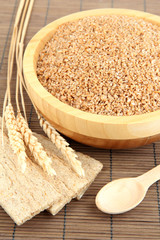 Wooden bowl full of wheat bran